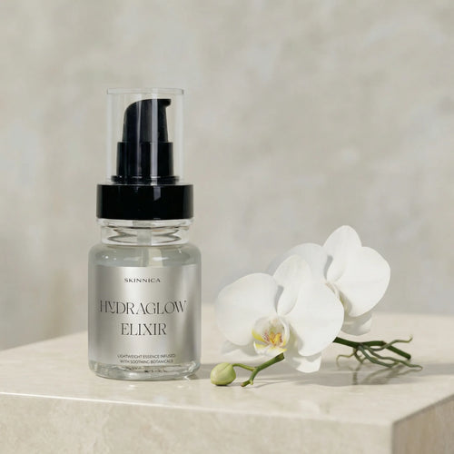 HYDRAGLOW ELIXIR bottle held against a warm neutral background showing product texture